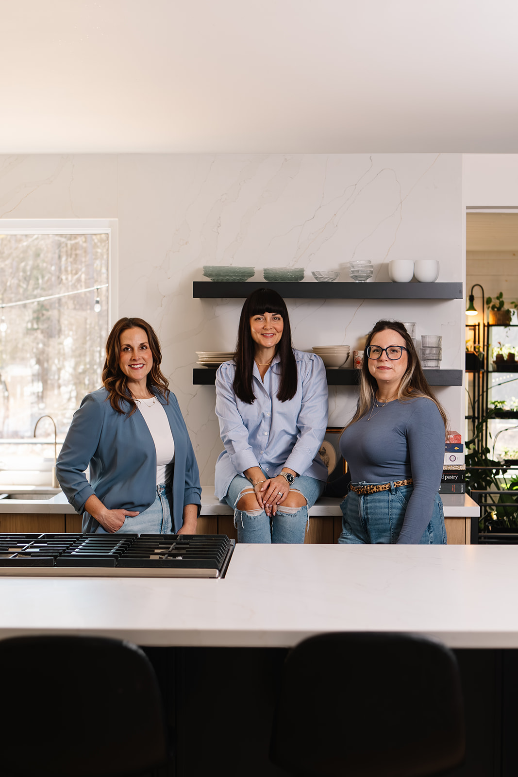NOCO Realty Group real estate team and sister standing in a kitchen together